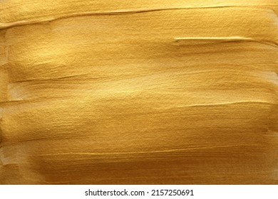Gold (bronze) color smear brushstroke stain blot horizontal background. Abstract Painting texture.