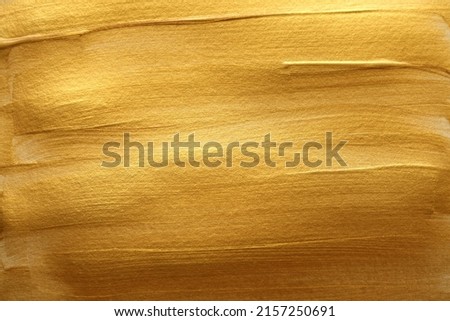Gold (bronze) color smear brushstroke stain blot horizontal background. Abstract Painting texture.