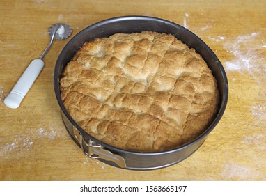 Gold Brown Pie In A Cake Tin Standing On An Old Kitchen Table