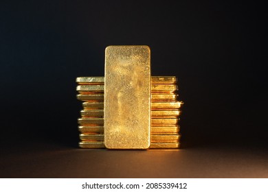 Gold bullion bar on dark background. Large cast investment gold ingot. Swiss gold. Business and finance. - Shutterstock ID 2085339412
