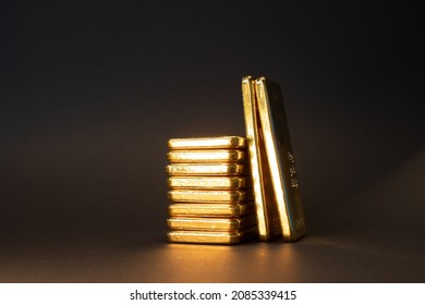 Gold bullion bar on dark background. Large cast investment gold ingot. Swiss gold. Business and finance. - Shutterstock ID 2085339415