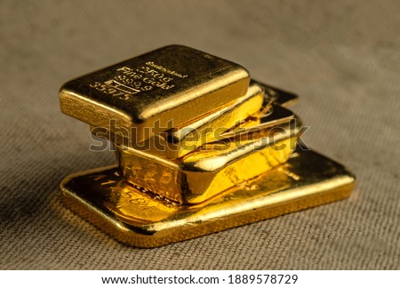 Gold bullion. A stack of gold bars of various weights. Selective focus