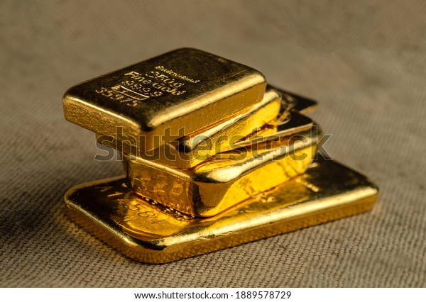 Gold bullion. A stack of gold bars of various\
weights. Selective focus