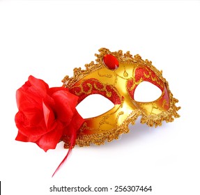 gold carnival mask with red flower isolated on white
