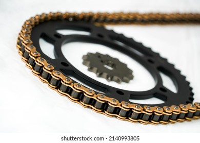 Gold chain and black sprocket red gold of motorcycles put on a white background.