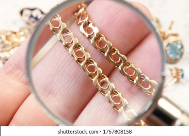 gold chain closeup, jewelry scrap of gold and silver and money, pawnshop concept jeweler looking at jewelry through magnifying glass, jewerly inspect and verify
