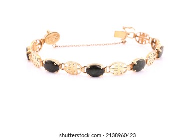 A Gold Charm Bracelet On A White Background.