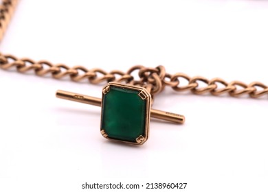 A Gold Charm Bracelet On A White Background.