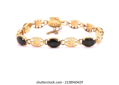 A Gold Charm Bracelet On A White Background.