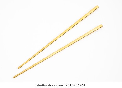 Gold chopsticks isolated on white background