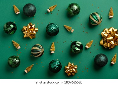 Gold Christmas Tree Decoration And Baubles On Green Background. Flat Lay, Top View. Merry Christmas Card