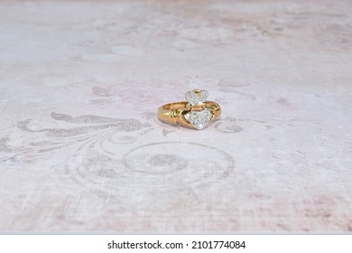 A Gold Claddagh Ring on Various Backgrounds