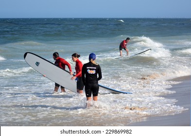 GOLD COAST, AUS - NOV 01 2014:Female wave surfing instructor teaches men and women how to surf in Surfers Paradise, Queensland, Australia.