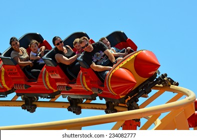 GOLD COAST, AUS -  NOV 06 2014:Visitors Ride On Road Runner Roller Coaster In Movie World Gold Coast Australia.It's A 335-metre (1,099 Ft) Junior Coaster Reaches A Top Speed Of 45.9 Kmh (28.5 Mph)