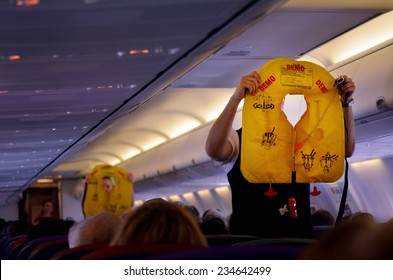 GOLD COAST, AUS - NOV 22 2014:Flight Attendants During Pre-flight Safety Demonstration.There Have Been 761 Deaths In 12 Commercial Aviation Accidents In 2014, According To The Aviation Safety Network.