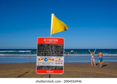 GOLD COAST, AUSTRALIA - APRIL 16, 2018: Lifeguard's yellow flag and safety Information at Main Beach Surfers Paradise. One of the main tourist destination at Gold Coast.