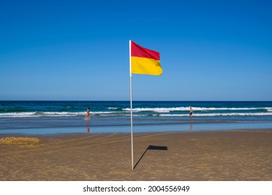 GOLD COAST, AUSTRALIA - APRIL 16, 2018: Lifeguard's red and yellow flag at Main Beach Surfers Paradise. One of the main tourist destination at Gold Coast.