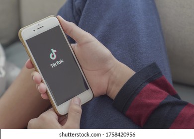 Gold Coast, Australia - June 17, 2020 :Teen Boy Hands Holding Smartphone With Tik Tok App On Screen