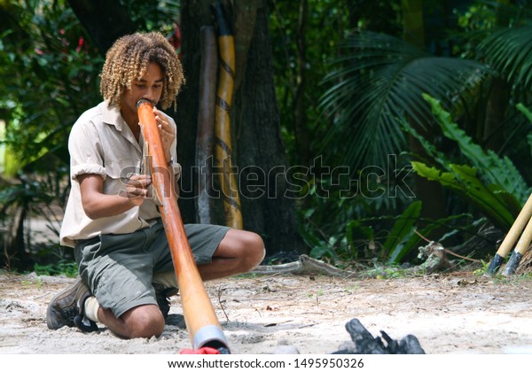 Gold Coast\
Australia on January 2, 2011. A local showing how to use a\
traditional instrument called a\
Didgeridoo.