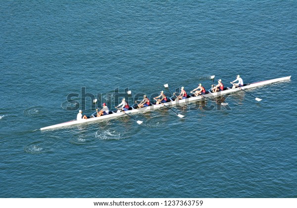 GOLD COAST - NOV 22\
2018:Aerial view of eight Australian rowers in a coxed eight (8+),\
a sweep rowing boat, In Surfers Paradise Gold Coast, Queensland\
Australia.