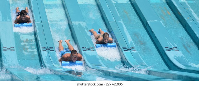 GOLD COAST - OCT 30 2014:Australian Family Rids On Super 8 Aqua Racer In Wet'n'Wild Gold Coast Water Park.In 2009, The Park Received 1,095,000 Visitors Ranking It First In Australia And 8 In The World