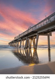 Gold Coast Pier at the Spit, Queensland - Australia, it a side view of the pier with a sunrise.