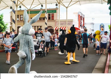 GOLD COAST, QUEENSLAND, AUSTRALIA - January, 2019: Bugs Bunny And Animated Cartoon Characters Walking Among The Crowd At Warner Bros. Movie World Theme Park. 