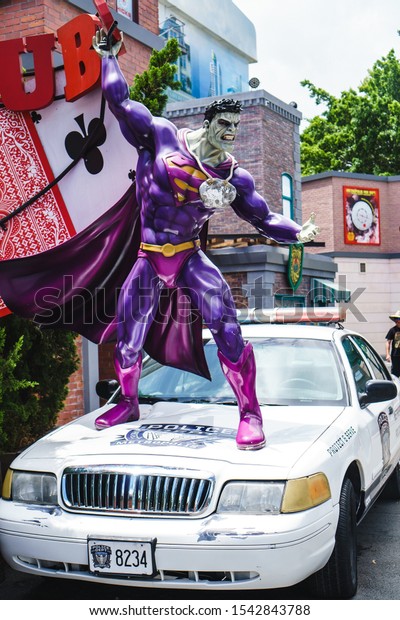 GOLD COAST, QUEENSLAND,\
AUSTRALIA - January, 2019: Super-Villain Bizarro stands on a police\
car and tears apart the Ace-O-Clubs bar at Warner Bros. Movie\
World