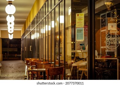 Gold Coast, Queensland, Australia - Nov 13, 2021: Empty Tables Next To The Gloria Jean's Cafe Shop Closed At Night