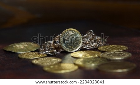 Gold coin 10 pounds Great Britain  Queen Elizabeth 2 on the background of jewelry and gold coins of Europe selective focus finance background