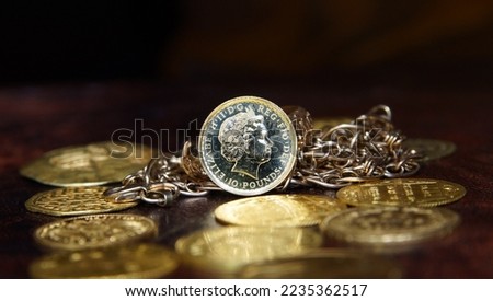 Gold coin 10 pounds Great Britain Queen Elizabeth 2 on the background of jewelry and gold coins of Europe selective focus finance background