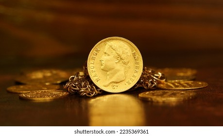 Gold coin 20 francs Napoleon France on the background of ancient gold coins and chains selective focus
money abstraction
