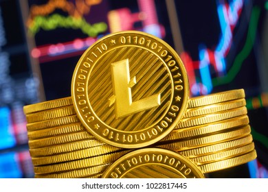 Gold coin litecoin stacked on a bright background of business graphics close-up. Crypto-currency LTC. Anonymous. Virtual currency                        