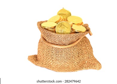 Gold coins in a canvas bag on white background