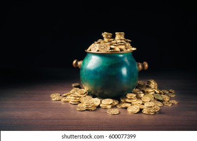 gold coins in a green pot on a dark background - Powered by Shutterstock