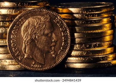 Gold coins of Napoleon III Emperor France on dark background