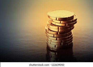 Gold coins on black background. Selective focus.