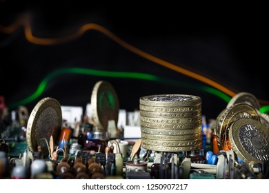 Gold coins on a circuit board showing electrical components. Light trails in the background bring life to the composition.
