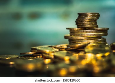 Gold coins stacks is representing riches and wealth management. Coin stack growing and find out the way to get a return on investment. Finance and money exchange investment as concept. - Shutterstock ID 1583129650