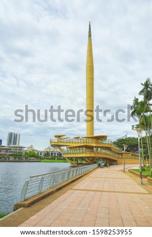 Gold color monument named Millennium Monument in Putrajaya, Malaysia.