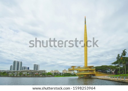 Gold color monument named Millennium Monument in Putrajaya, Malaysia.