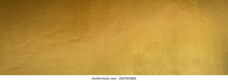 Gold color old grunge wall concrete texture as background, Wide banner.