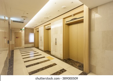 Gold Colored Elevator Door And Corridor(hall, Passage) And Marble Bottom, Wall At The Hotel In South Korea.