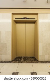 Gold Colored Elevator Door And Corridor(hall, Passage) And Marble Bottom, Wall At The Hotel In South Korea.