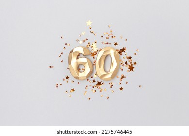 Gold colored number 60 and stars confetti on a blue background. Festive creative concept.