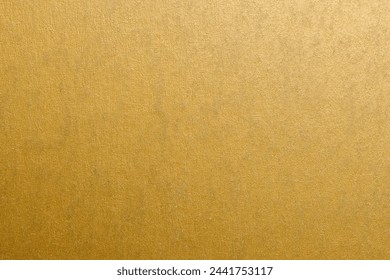 A gold colored wall with a patterned texture. The wall is very shiny and has a warm, inviting feel