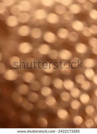 Gold coloured unsharp lights on a brown background.