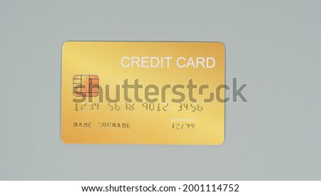 Gold credit card isolated on grey background.Nopeople.