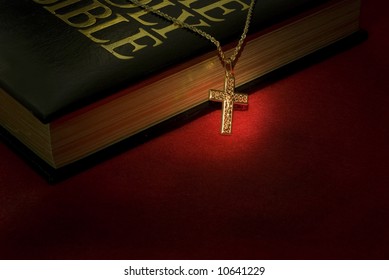 A Gold Cross Necklace On A Holy Bible