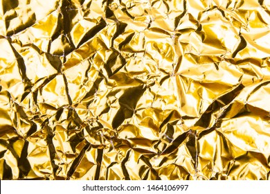 Gold crumpled foil paper texture background. - Shutterstock ID 1464106997